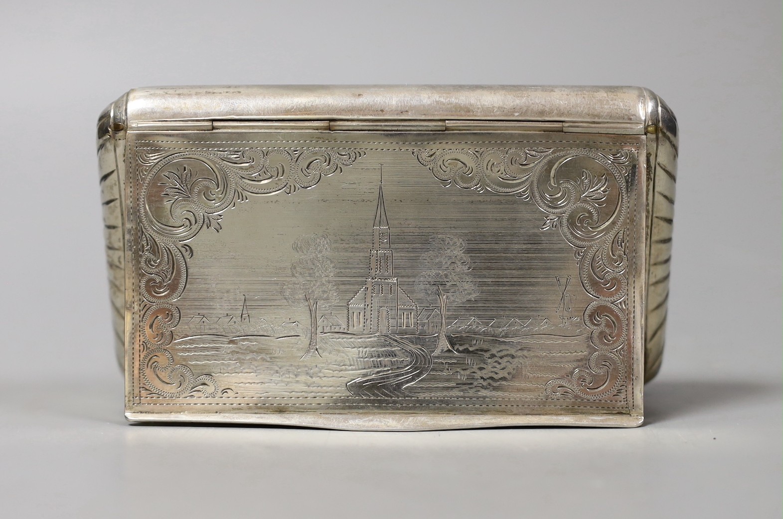 A 19th century Dutch 833 standard white metal tobacco box, engraved with a church in landscape scene, 13.2cm, 159 grams.